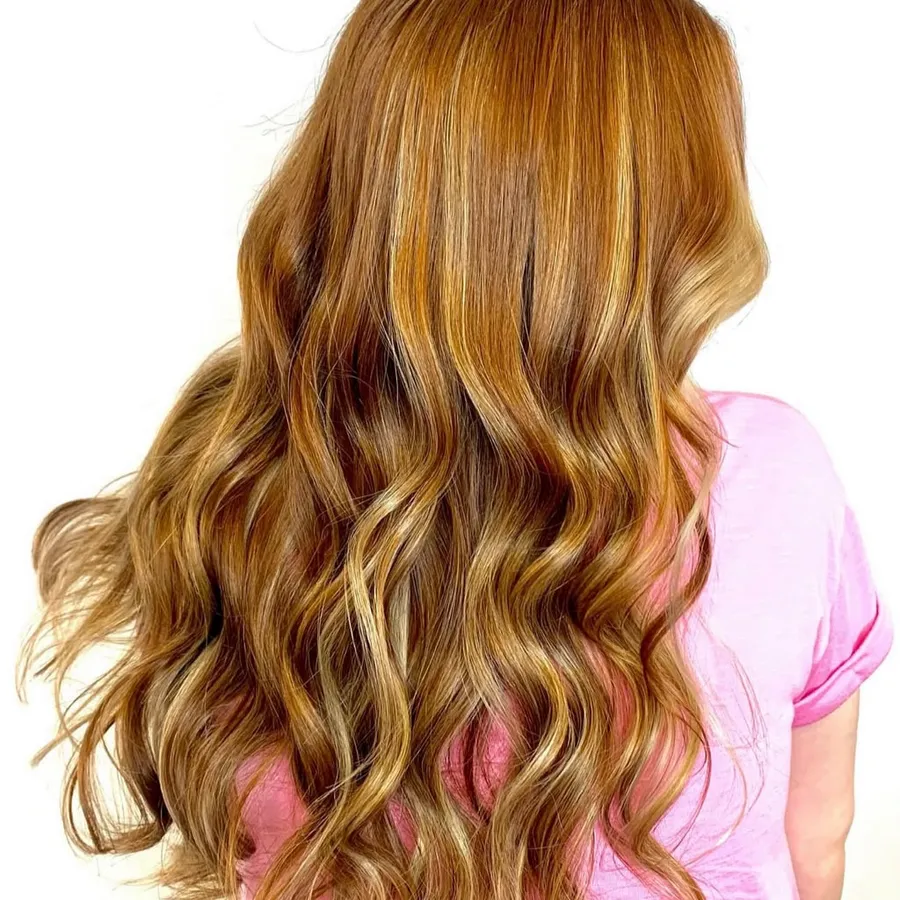 Long copper and gold wavy hair color by A Cut Above